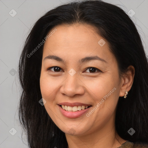 Joyful asian young-adult female with long  brown hair and brown eyes