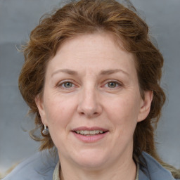 Joyful white adult female with medium  brown hair and blue eyes