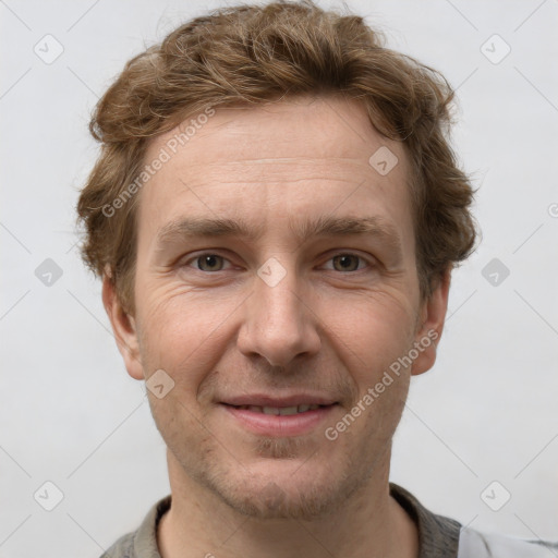 Joyful white adult male with short  brown hair and grey eyes