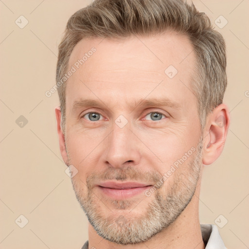 Joyful white adult male with short  brown hair and grey eyes