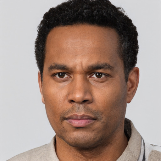 Neutral black adult male with short  black hair and brown eyes