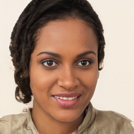 Joyful black young-adult female with short  brown hair and brown eyes