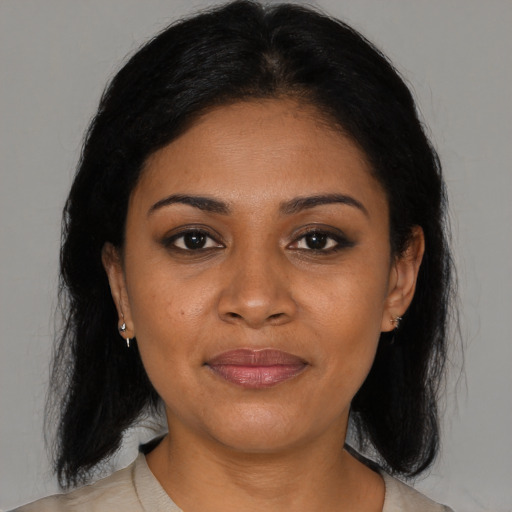 Joyful black young-adult female with medium  brown hair and brown eyes
