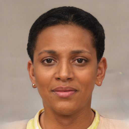 Joyful black young-adult female with short  black hair and brown eyes