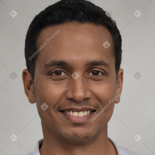 Joyful latino young-adult male with short  black hair and brown eyes