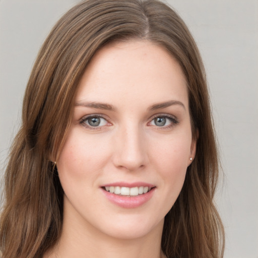 Joyful white young-adult female with long  brown hair and green eyes