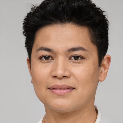 Joyful asian young-adult male with short  brown hair and brown eyes