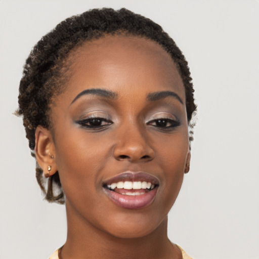 Joyful black young-adult female with short  brown hair and brown eyes