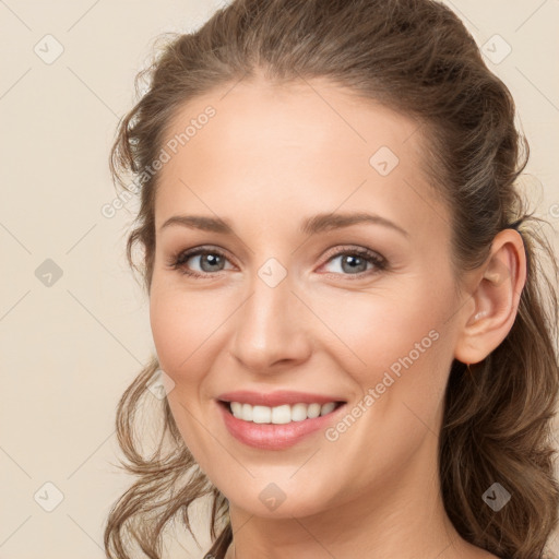 Joyful white young-adult female with long  brown hair and grey eyes