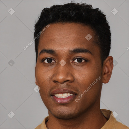 Joyful black young-adult male with short  black hair and brown eyes