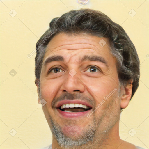 Joyful white adult male with short  brown hair and brown eyes