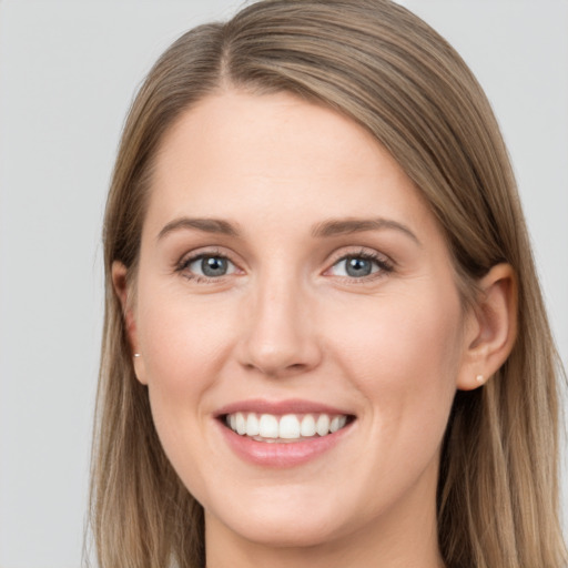 Joyful white young-adult female with long  brown hair and grey eyes