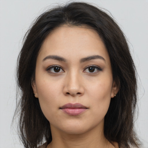 Neutral latino young-adult female with long  brown hair and brown eyes