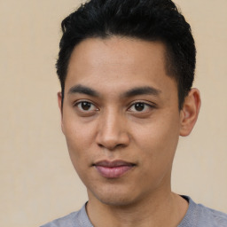 Joyful asian young-adult male with short  black hair and brown eyes