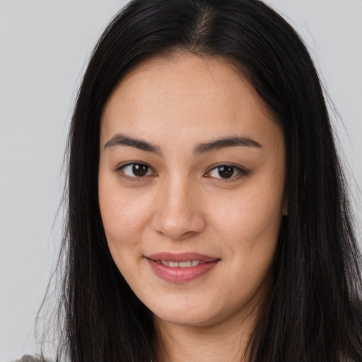 Joyful asian young-adult female with long  brown hair and brown eyes