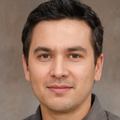 Joyful white adult male with short  brown hair and brown eyes