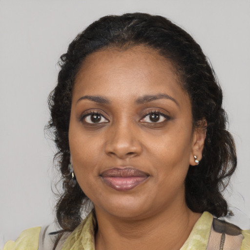 Joyful black adult female with medium  black hair and brown eyes