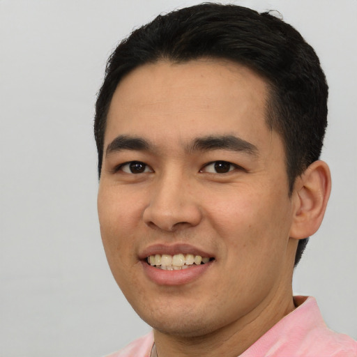 Joyful asian young-adult male with short  black hair and brown eyes