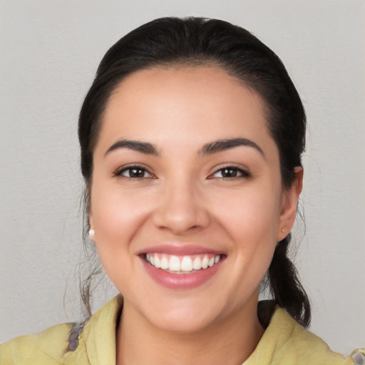 Joyful white young-adult female with medium  black hair and brown eyes