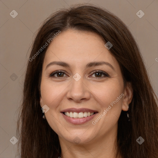 Joyful white adult female with long  brown hair and brown eyes