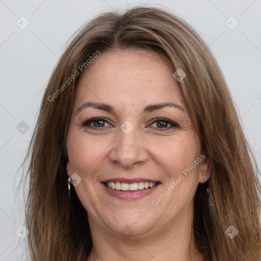 Joyful white adult female with long  brown hair and brown eyes