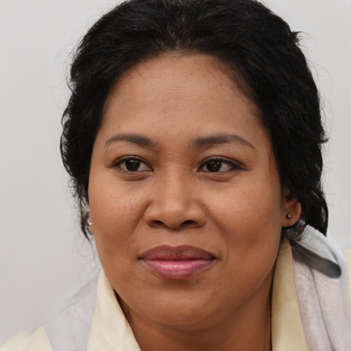 Joyful asian adult female with medium  brown hair and brown eyes