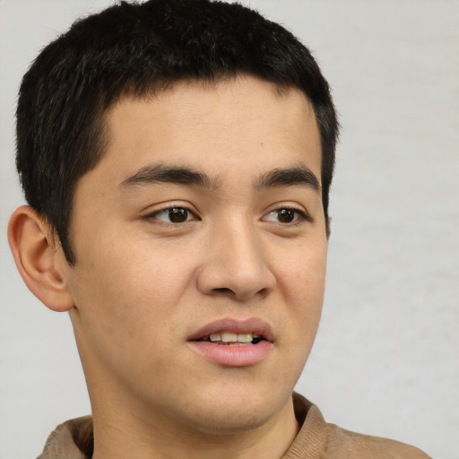 Joyful latino young-adult male with short  black hair and brown eyes