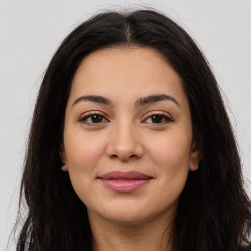Joyful latino young-adult female with long  brown hair and brown eyes