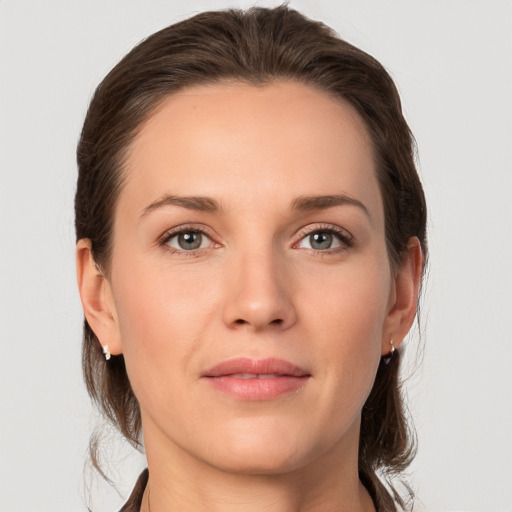 Joyful white young-adult female with medium  brown hair and grey eyes