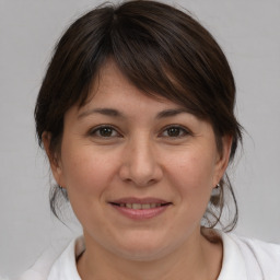 Joyful white adult female with medium  brown hair and brown eyes