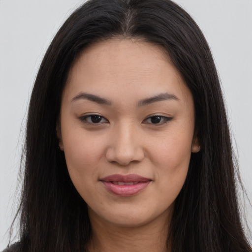 Joyful asian young-adult female with long  brown hair and brown eyes
