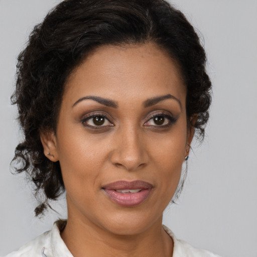 Joyful black young-adult female with medium  brown hair and brown eyes