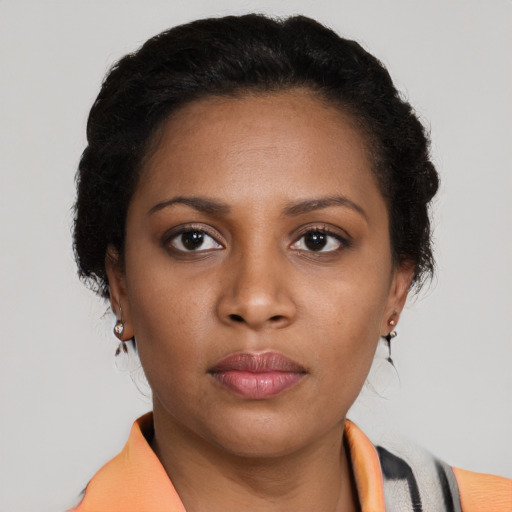 Neutral black young-adult female with medium  brown hair and brown eyes