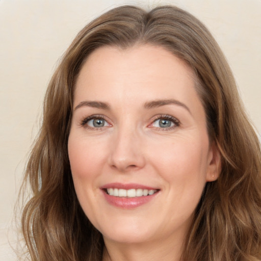 Joyful white young-adult female with long  brown hair and green eyes