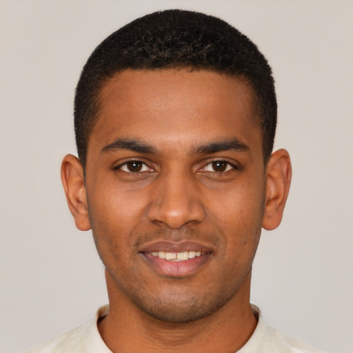 Joyful black young-adult male with short  black hair and brown eyes