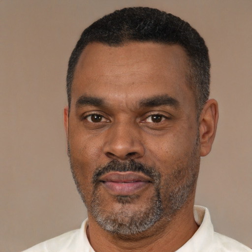 Neutral latino adult male with short  black hair and brown eyes