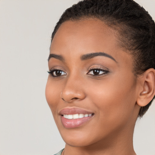 Joyful latino young-adult female with short  brown hair and brown eyes