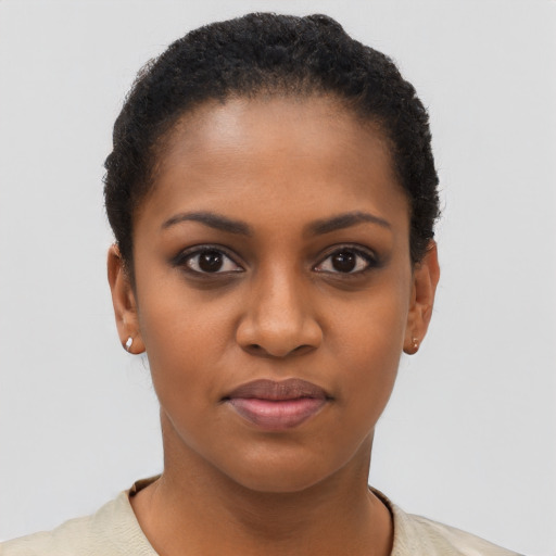 Joyful black young-adult female with short  brown hair and brown eyes