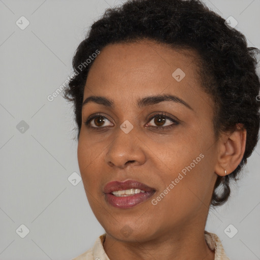 Joyful black young-adult female with short  brown hair and brown eyes