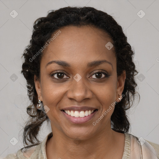 Joyful black young-adult female with long  brown hair and brown eyes