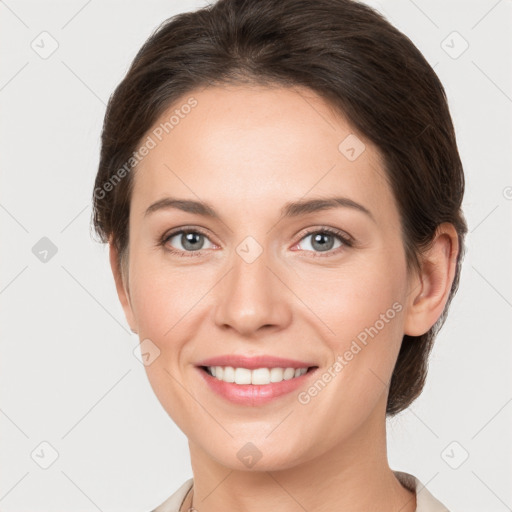 Joyful white young-adult female with medium  brown hair and grey eyes