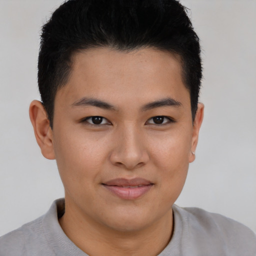 Joyful asian young-adult male with short  brown hair and brown eyes