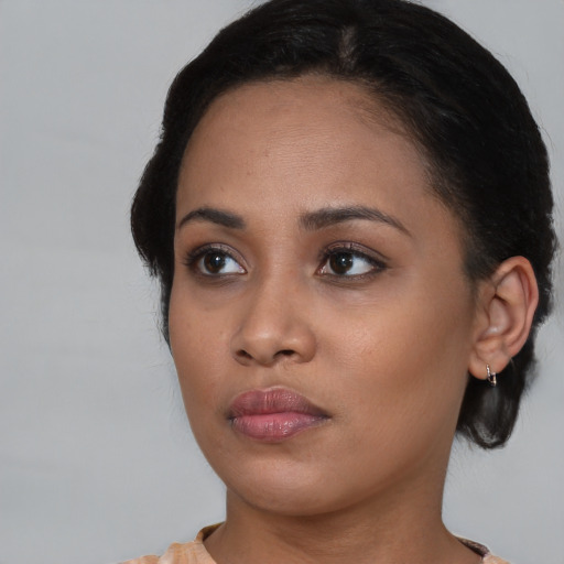 Neutral black young-adult female with medium  black hair and brown eyes