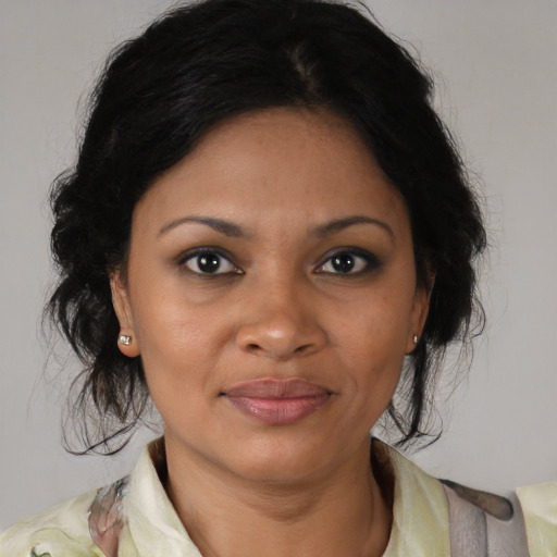 Joyful black young-adult female with medium  brown hair and brown eyes