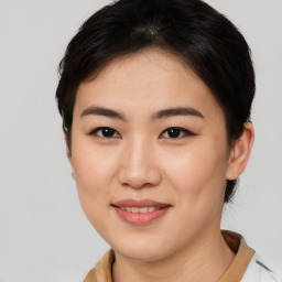 Joyful asian young-adult female with short  brown hair and brown eyes