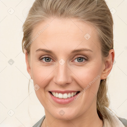 Joyful white young-adult female with medium  brown hair and blue eyes