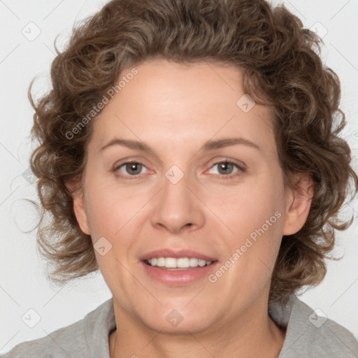 Joyful white adult female with medium  brown hair and blue eyes