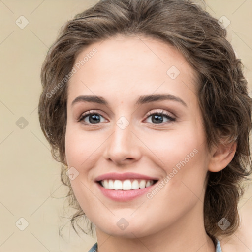 Joyful white young-adult female with medium  brown hair and green eyes