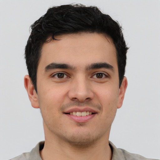 Joyful latino young-adult male with short  brown hair and brown eyes