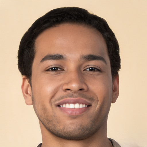 Joyful latino young-adult male with short  brown hair and brown eyes